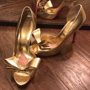 Paris Hilton gold bow heels